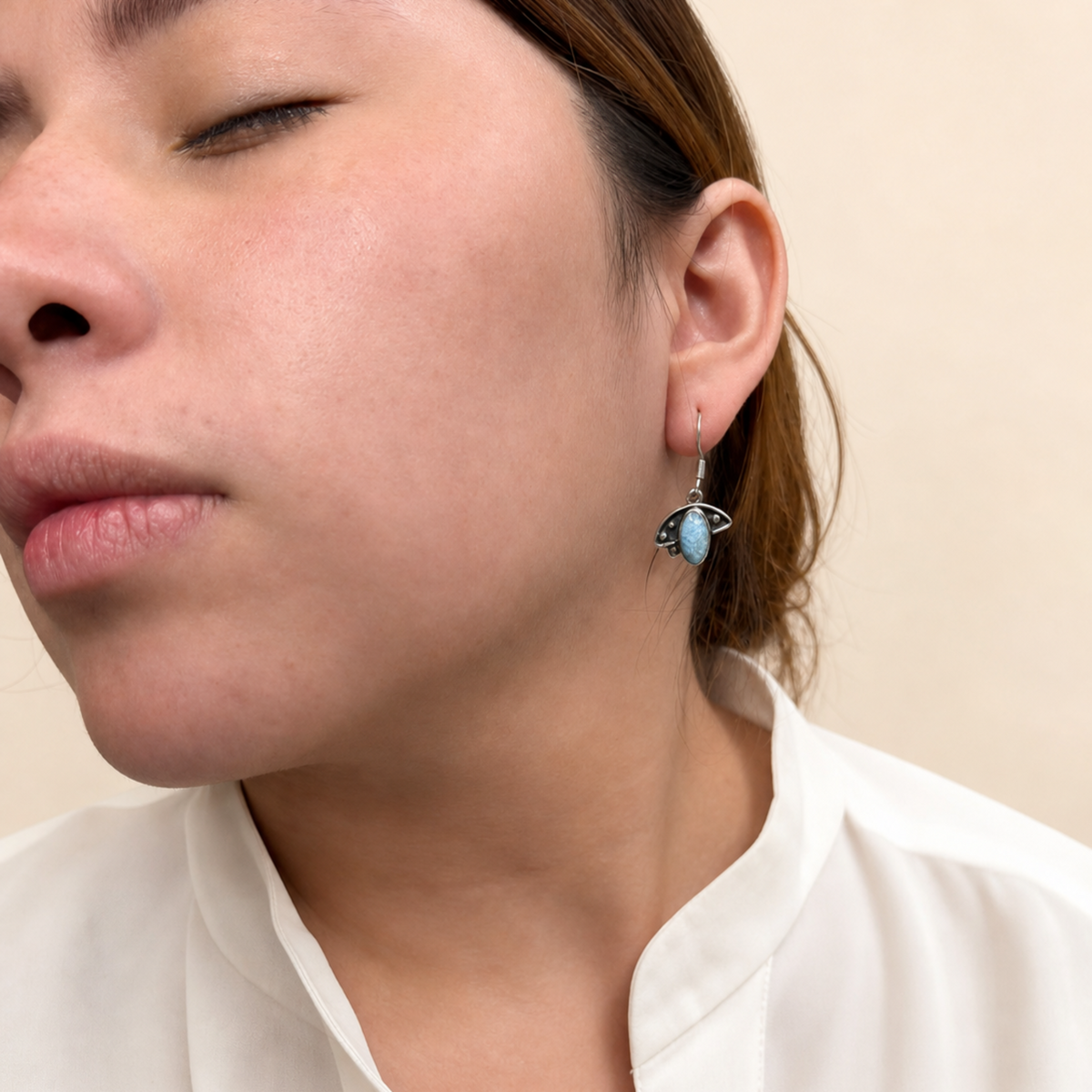 Dangle earrings in the shape of a flight, made of larimar stone.